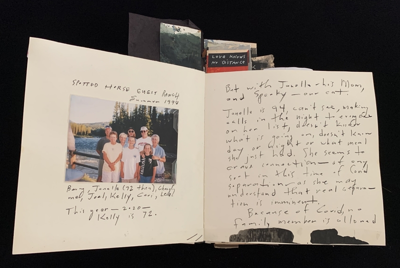 An open scrapbook showing a family photo and handwritten notes.