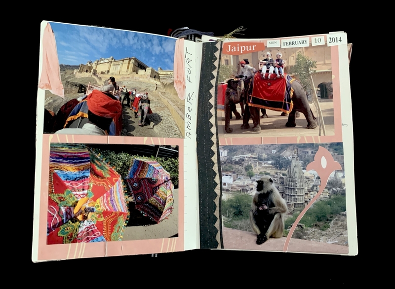 Open scrapbook with photos of a fort, colorful umbrellas, people on elephants, and a monkey with a temple in the background.