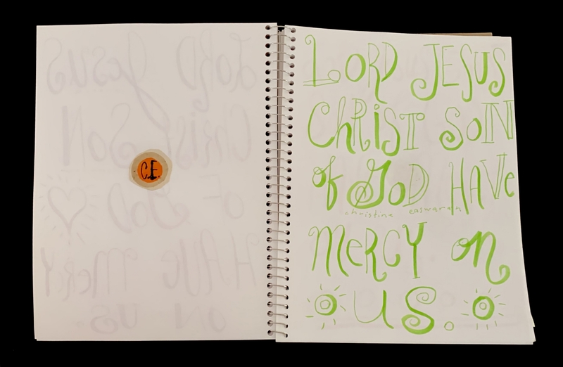 A page from a notebook featuring handwritten text and a small circular sticker.