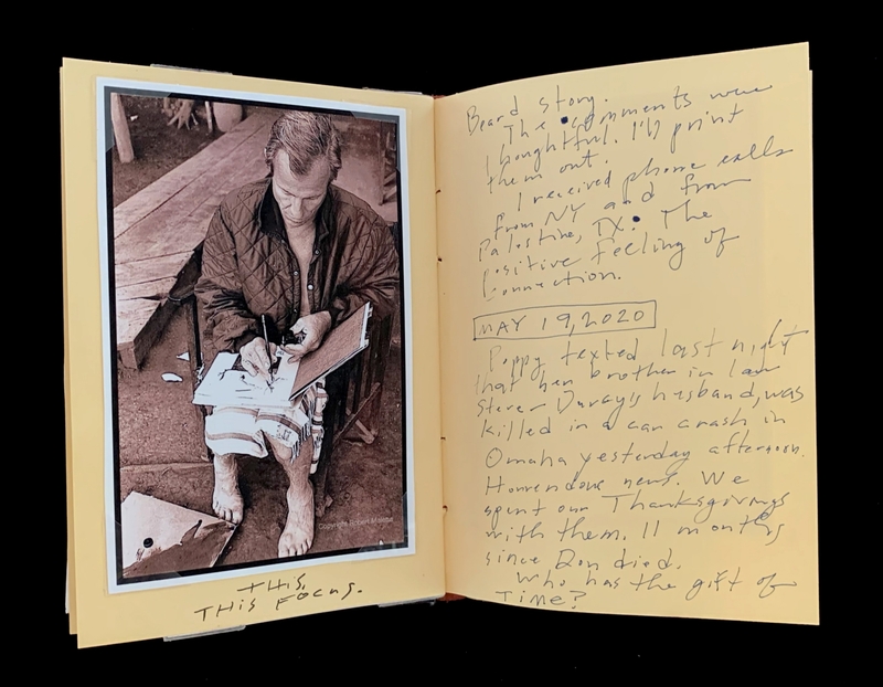 A photograph of a person sitting on a step, writing in a notebook, accompanied by handwritten notes on the right-hand page.