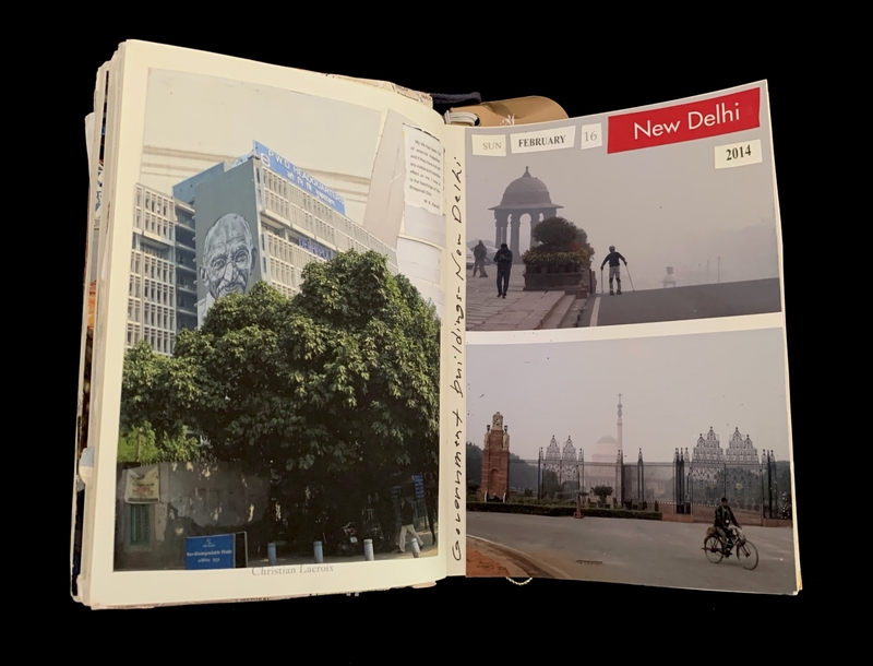 An open notebook showing photos of a building with a mural, a misty scene with a monument, and a cyclist near a domed building.