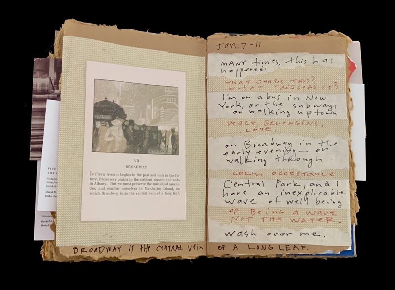 An open scrapbook with a print of Broadway and handwritten text.