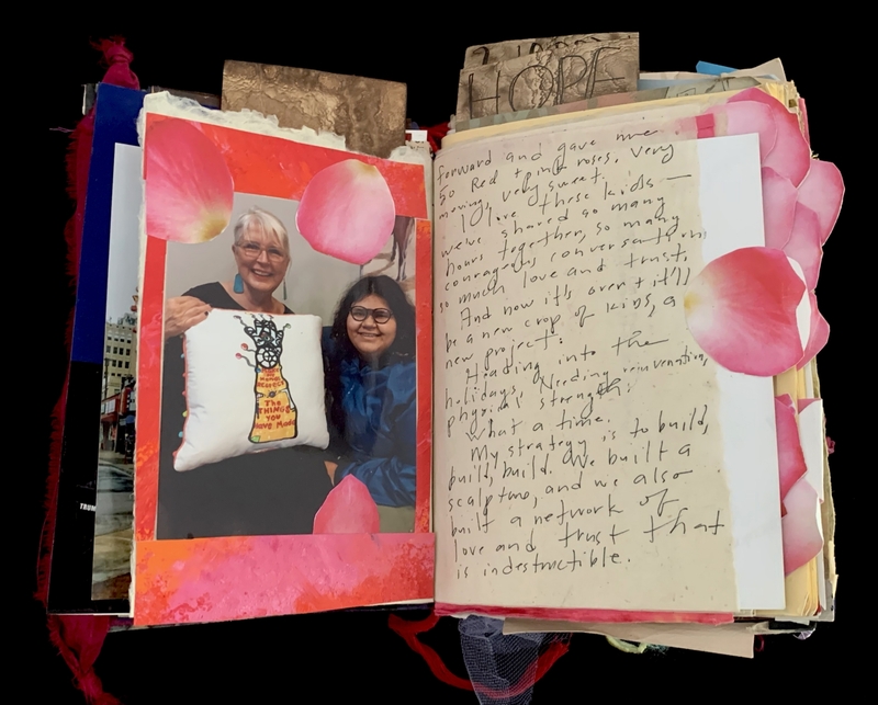 A scrapbook page featuring a photograph of two individuals holding a pillow, surrounded by decorative elements and handwritten notes.