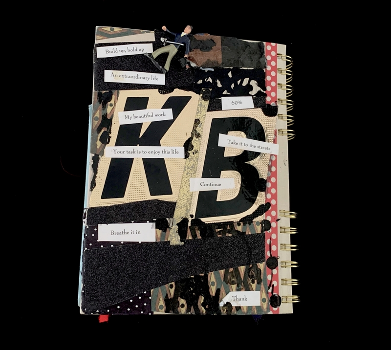 A collage-style notebook cover featuring bold text, phrases, and abstract elements.