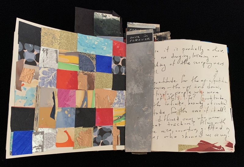 Open book with a colorful collage and cursive handwriting.