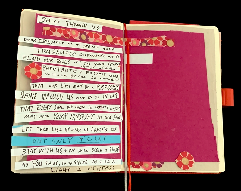 An open notebook with handwritten text on decorated paper strips.