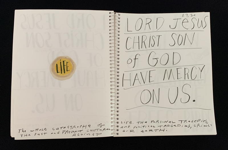 A handwritten prayer page with a sticker and additional text.