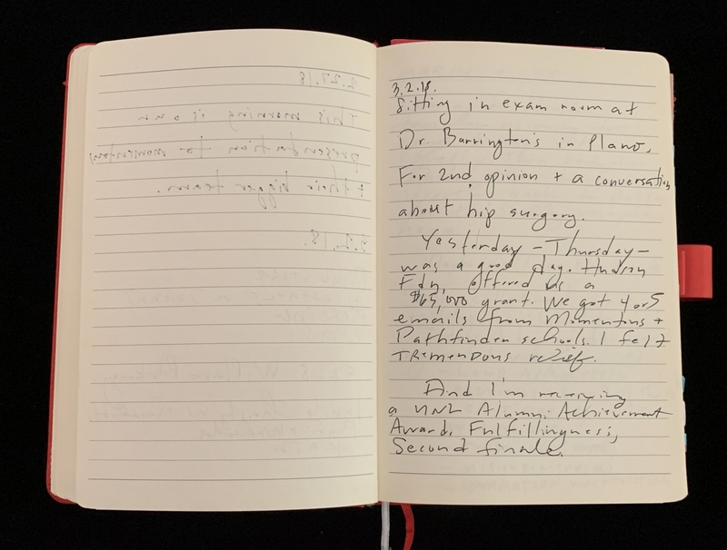 Open notebook with handwritten notes on the right page.