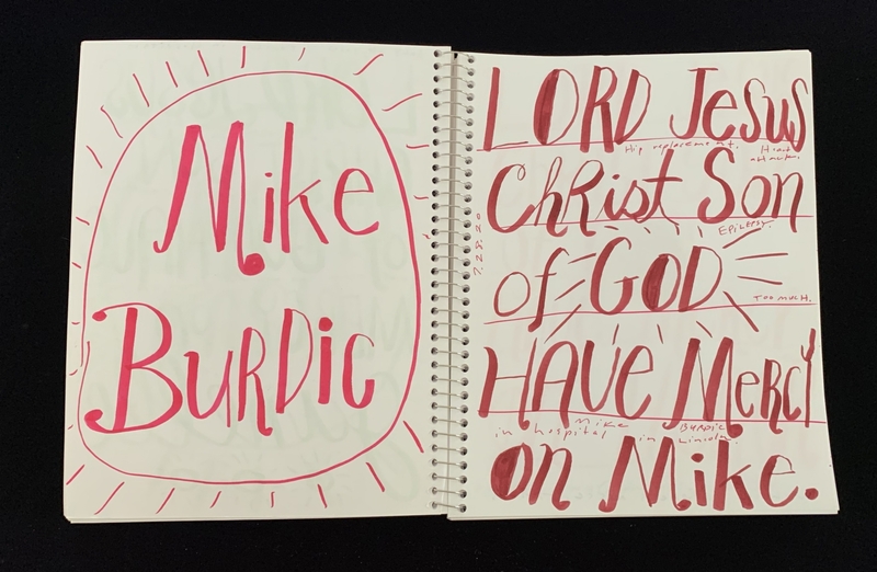 A handwritten page featuring a name and a prayer, with decorative elements.