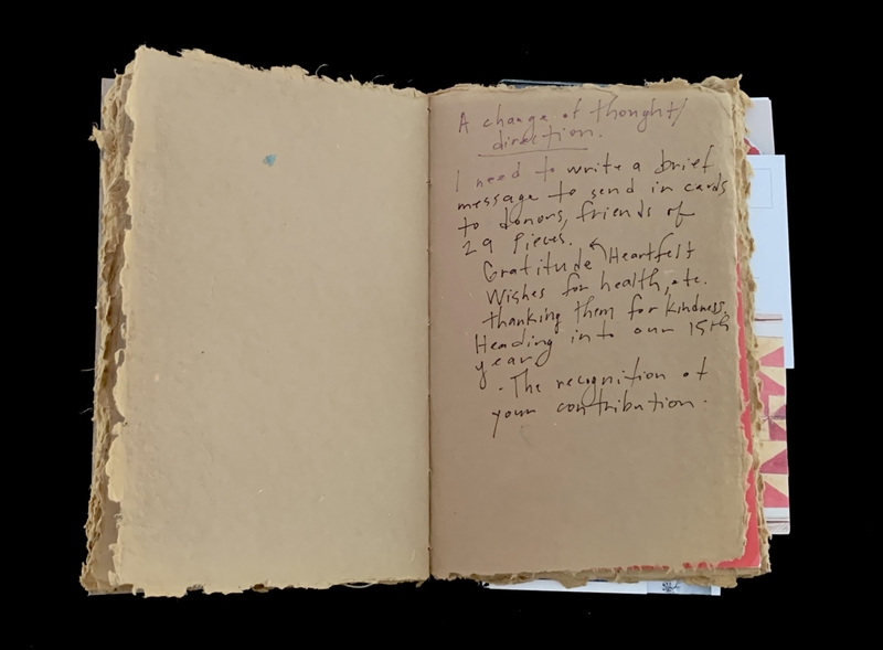 An open, rustic notebook with handwritten text on the right page.