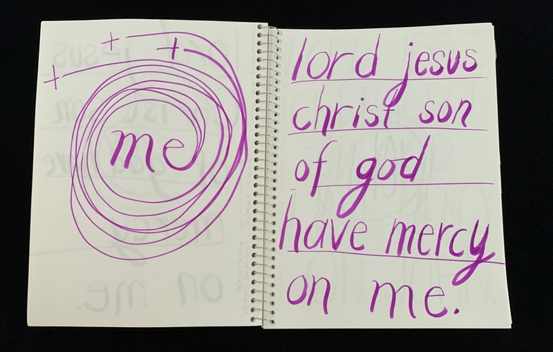 A handwritten page featuring a religious prayer and a circular doodle.