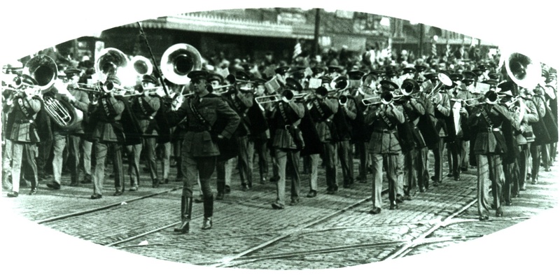 Picture of Carrol Panley (drum major) leading the R.O.T.C. Band down "O" street in Lincoln, Nebraska during the 1929 Armistice Parade.