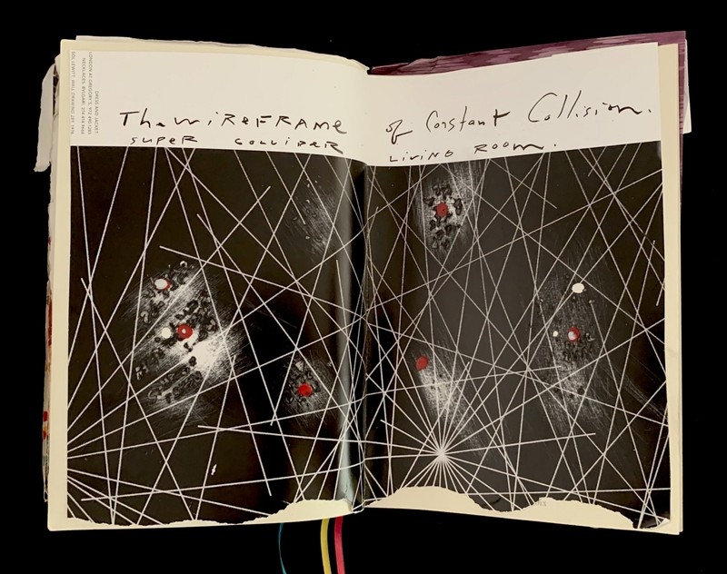 Open journal with abstract artwork of intersecting lines and text: "The wire FRAME of constant collision. Super collider living room."