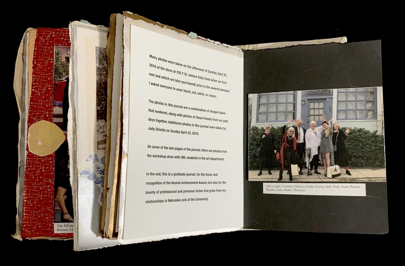 Open journal with text and a group photo on opposing pages.