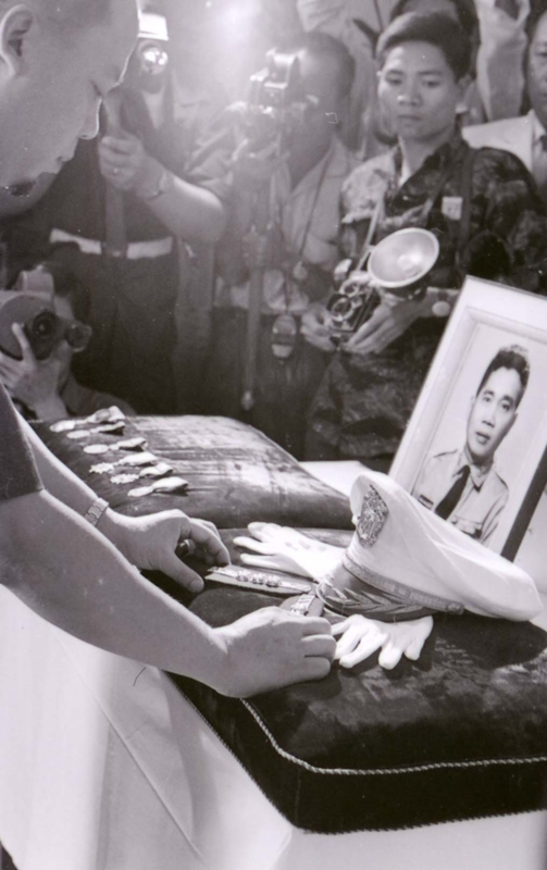 Nguyá»…n KhÃ¡nh attending a funeral. He is leaning into an altar.