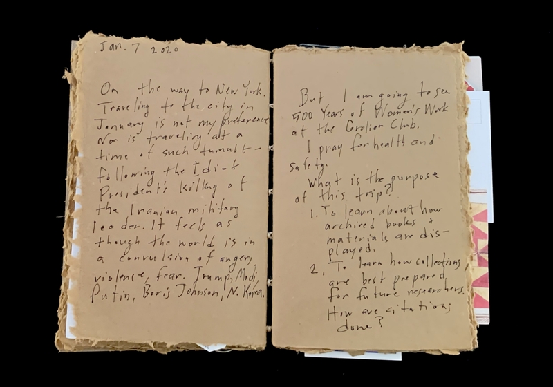 Open journal with two pages of handwritten text.