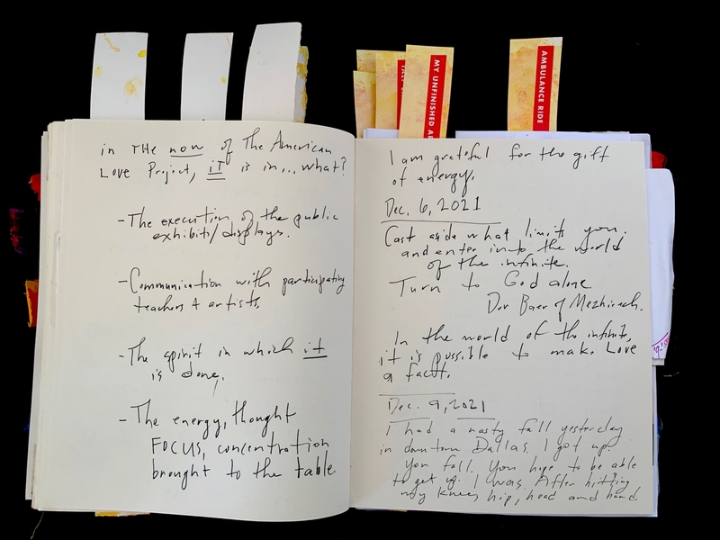 Open journal with handwritten notes and colorful tabs on top.