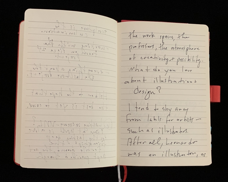 Open notebook with handwritten text on lined pages, red cover visible.