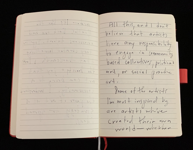 Open notebook with handwritten text on lined pages, one page faint and the other clear.