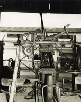 "During the week of 28 Apr., U.S. Forces fighting in the A Shau valley have captured various Soviet-built weapons and components from the North Vietnamese. The sophistication of these captured weapons and the firepower that they represent pose a definite increase in the threat to allied forces. In addition, the recovery of these items reflected the continued support of North Vietnam by the Soviet Union. Soviet 37mm anti-aircraft weapon. This captured weapon was designed in 1939 and probably manufactured around 1945. It is effective against aircraft to a maximum altitude of 19,000 feet and is manned by a crew of five." A machine gun in a storage facility.