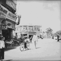 "Ca Mau" Street full of bikes and people.