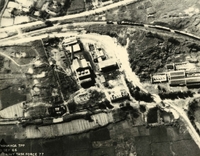 "Before and After near Thanh Hoa, North Vietnam - Navy jet pilots of Carrier Air Wing 15 pounded a railroad ferry complex northeast of Thanh Hoa Sep. 21-23, 1966. Targets included a thermal power plant, defending flak sites, railways, boxcars, and roads. After the raid shown in these before and after photos, Navy Intruder and Skyhawk pilots described the area as 'devastated.'" Aerial photography of buildings, farm fields, a railroad, and roads.