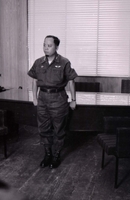 Nguyá»…n KhÃ¡nh standing at a formal meeting.