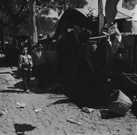 "Macau" Young children standing in the road in a slum.