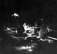 "Korea-Negs 181-3(1)-182-3(1) Fertilizer Plant-Chungyu- USAID 8" Exterior of a factory at night. From scrapbook page 23.