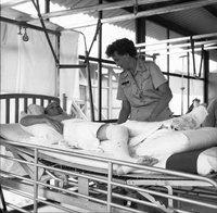 An American nurse tends to her patient.