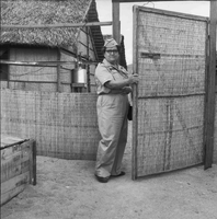 An American woman's photo is taken as she opens a gate.