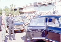 Trip with Nguyễn Cao Kỳ to Montagnard Ceremony, Pleiku. A group of Vietnamese men, some in military uniform, get into a car.