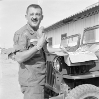 Original title "Cao Lanh - XON + MAAG ", a man (police officer) standing next to a car