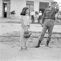 "QN + Train ", a photo of a soldier talking to the kid and pointing at something, kids and other soldier in a buiding in the background