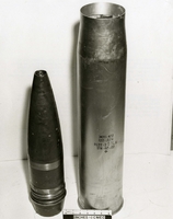 "During the week of 28 Apr., U.S. Forces fighting in the A Shau valley have captured various Soviet-built weapons and components from the North Vietnamese. The sophistication of these in firepower that they represent pose a definite increase in the threat to allied forces. In addition, the recovery of these items reflect the continued support of North Vietnam by the Soviet Union. Ammunition for the Soviet 122mm Field Gun. Projectiles and cartridge cases were in the original Soviet packing crates. The Soviet 122mm Field Gun is a light, mobile field gun weighing approximately 18,000 pounds. It is normally towed by a medium tracked artillery tractor. This weapon has a maximum range of approximately 22,000 meters (14 miles) The photograph shows two rounds, one HE and the other APHE-T." An explosive broken into two pieces.