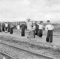 "QN + Train ", picture of a group of people stamding, dancing?