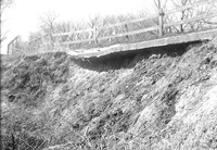 Original caption: Salt Creek bridge West of penitentiary detail of damaged paving. Apr. 16, 1922