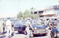 Trip with Nguyễn Cao Kỳ to Montagnard Ceremony, Pleiku. A group of Vietnamese men, some in military uniform, get into a car.