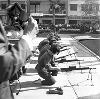 Original caption: "Mne. Nhu + Paramilit. Graduation - 27 Feb 63" Several Vietnamese paramilitary women loading guns in a line.