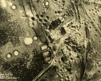 "Before and After near Thanh Hoa, North Vietnam - Navy jet pilots of Carrier Air Wing 15 pounded a railroad ferry complex northeast of Thanh Hoa Sep. 21-23, 1966. Targets included a thermal power plant, defending flak sites, railways, boxcars, and roads. After the raid shown in these before and after photos, Navy Intruder and Skyhawk pilots described the area as 'devastated.'" Aerial photo of a bombed landscape with roads, destroyed buildings, a railway, a river, and farms.