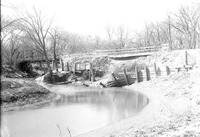 Original caption: Salt Creek bridge west of penitentiary from south showing bridge and undermined pavement. Apr. 16, 1922