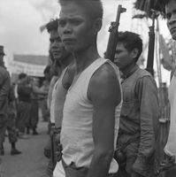"Montagnards - Showplace Strat. Ham - 8-21-62 - In MTs - Faces - Blockhouses" Men looking at the camera - they have guns strapped to their backs.