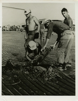 Original title: "Quick Change Artists."  "Seabee steelworkers remove damaged M8Al steel matting from the parking apron at Dong Ha airfield (Official U.S. Navy Photograph)." Steelworkers removed damaged steel. Seabees news release 79-67 (34).