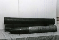 Original caption: "Shown here is a Russian made 140mm rocket and launcher, used for the first time in Vietnam against the Da Nang Air Base on 27 Feb. The rocket is 43 inches long, weighs approximately 90 pounds and has a range of over five miles." A missile sits on a table.