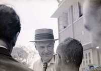 Henry Cabot Lodge Jr is stopped by a reporter with a microphone.