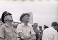Henry Cabot Lodge Jr wearing a hat standing next to an American military officer.