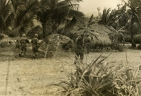 "Bong Son, Vietnam - Moving through a village during Operation 'Pershing', soldiers of the U.S. Army's 1/9th Calvary, 1st Calvary Division (Airmobile) search every hut for the suspected Viet Cong." Three American soldiers walking through a Vietnamese village. There is a traditional thatched roof house in the background.
