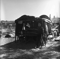 "Macau" A young boy is standing in front of a shop, another boy's silhoette in the background.