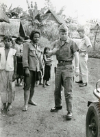 An American soldier named "Hibbs" talking with Vietnamese villagers.