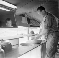 "QN + Train ", picture of a soldier washing their hands by the sink, reslection on the mirror